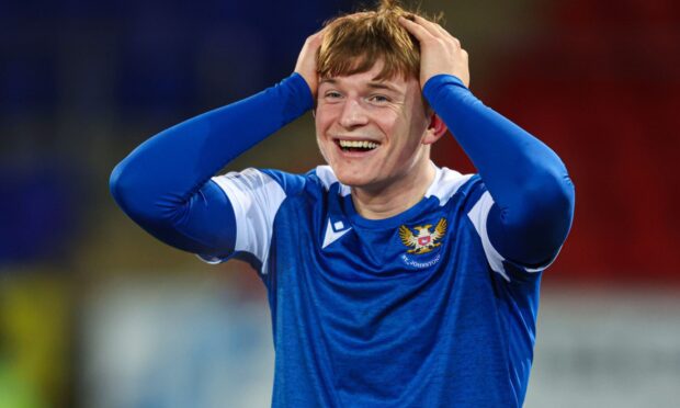 A smiling Fran Franczak with his hands on his head.