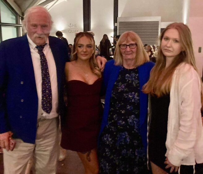 Scott and Jane Goring at an event with grandaughters Bobi and Winona in dresses