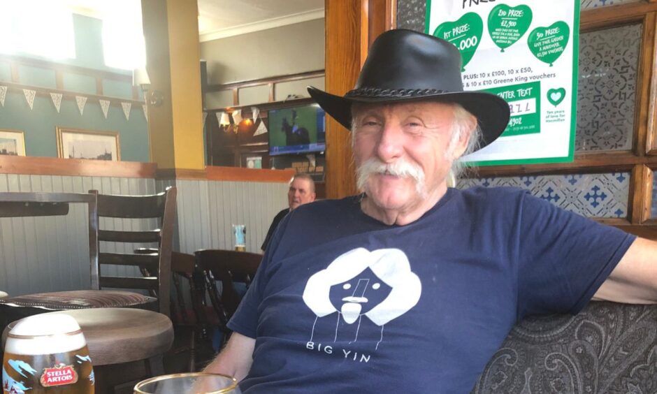 Scott Goring wearing cowboy hat and 'big yin' T shirt