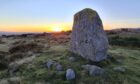 standing stones with countryside behind