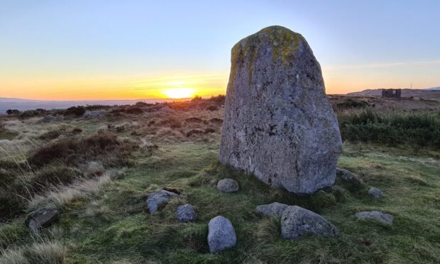 standing stones with countryside behind