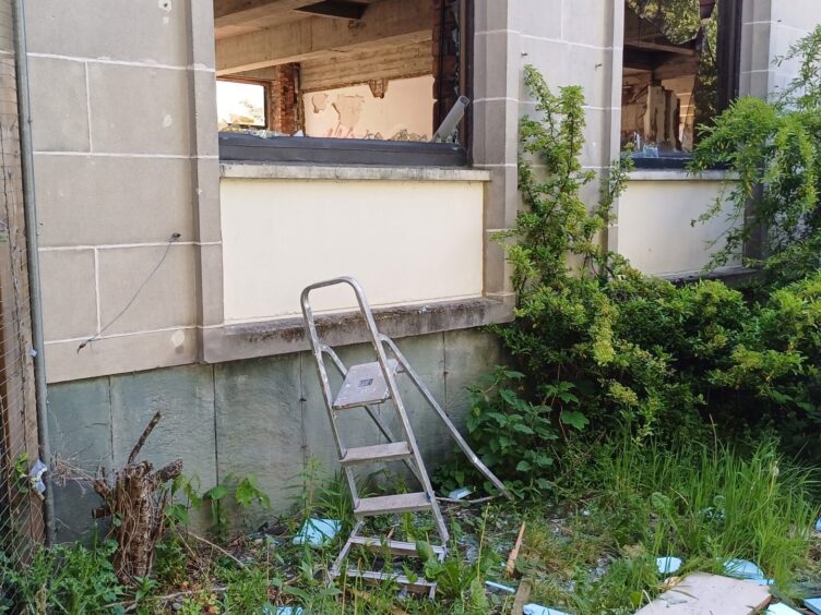 A ladder beneath a broken window
