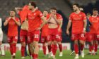 Disappointed Raith Rovers players trudge off the pitch after learning their play-off fate.