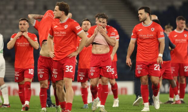 Disappointed Raith Rovers players trudge off the pitch after learning their play-off fate.