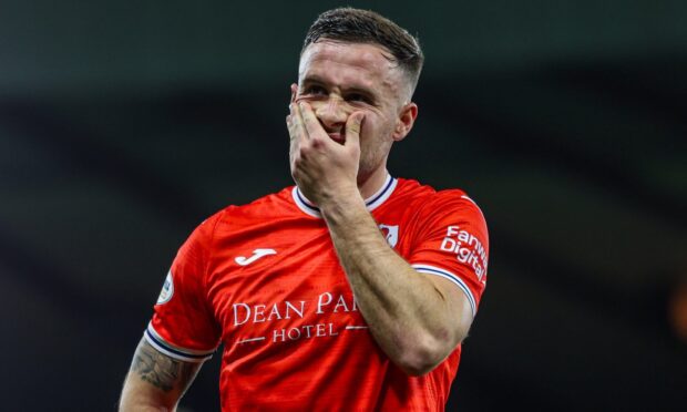 Raith Rovers striker Lewis Vaughan holds his left hand up to his face as he displays his disappointment.