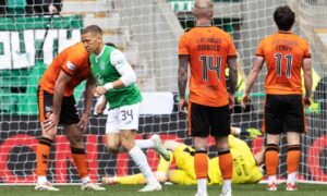 Hibenrian's Dwight Gayle wheels away after making it 3-1 against Dundee United