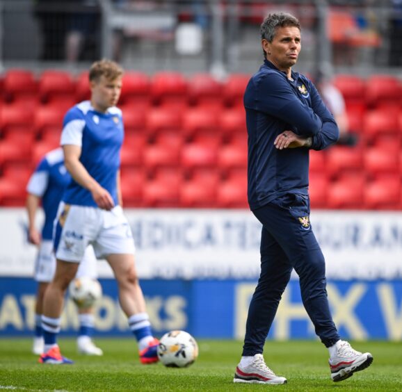 Simo Valakari watches his team's pre-match warm-up.
