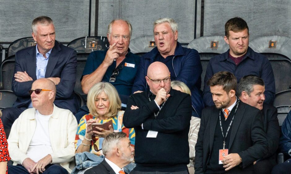Blackpool boss Steve Bruce, back row second from right, taking in Saturday's action at Tannadice