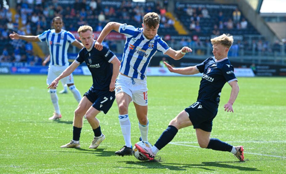 Lyall Cameron wins the ball in a tackle with Kilmarnock's David Watson as Dundee team-mate Scott Tiffoney looks on.