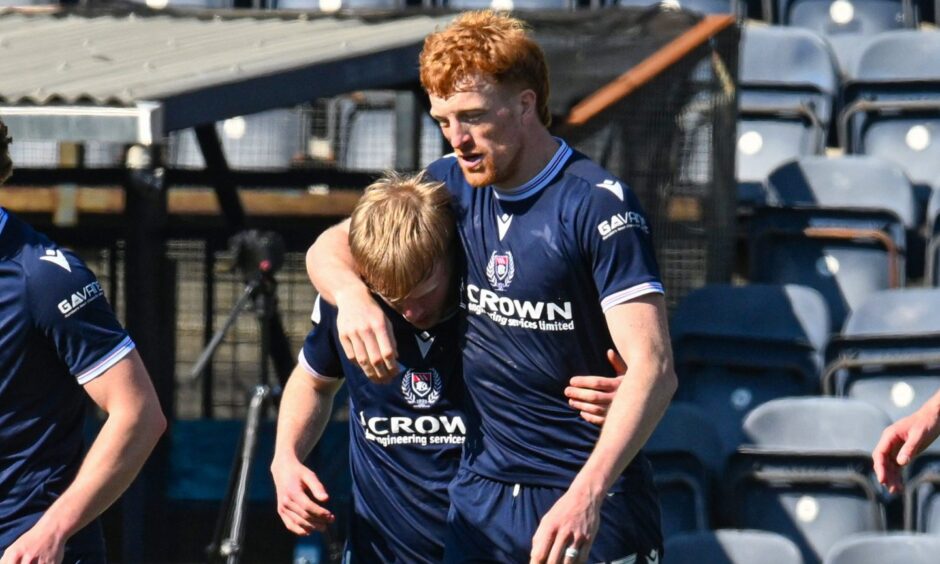 Simon Murray has his arm round the shoulders of Lyall Cameron.