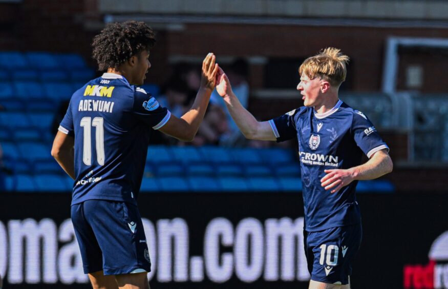Seun Adewumi gives goal-scorer Lyall Cameron a high five.