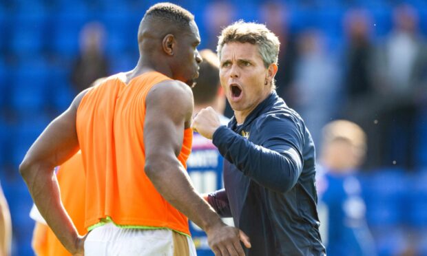 St Johnstone head coach Simo Valakari celebrates at full-time with Uche Ikpeazu.