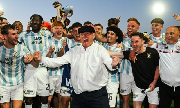 Dick Campbell is surrounded by his East Fife players and staff as he leads the celebrations after the full-time whistle.