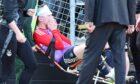 Aberdeen defender Jack MacKenzie receives treatment after the incident. Image: Roddy Scott/SNS Group