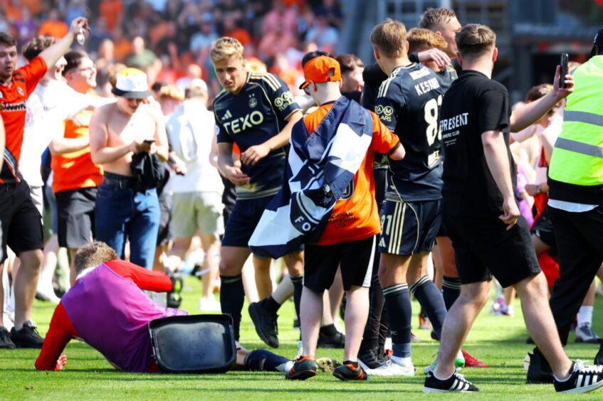 Jack Mackenzie hits the turf after being struck.