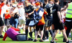 Jack Mackenzie hits the turf after being struck.