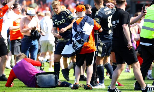 Jack Mackenzie hits the turf after being struck.