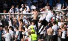Dundee fans climb on to crossbar at McDiarmid Park at full-time. Image: Paul Devlin/SNS Group