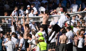 Dundee fans climb on to crossbar at McDiarmid Park at full-time. Image: Paul Devlin/SNS Group