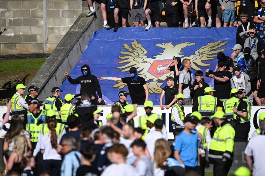St Johnstone fans had to watch Dundee supporters celebrating on their pitch.