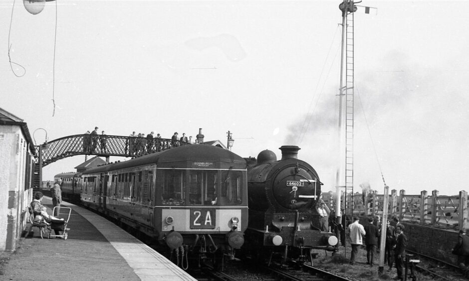 Number 64602 alongside the Edinburgh train during a stop at Elie in 1965.