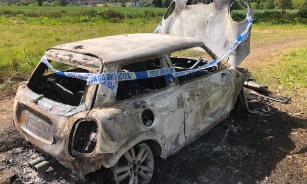 The burnt-out car at Baldovan Wood, north of Dundee. Image: James Simpson/DC Thomson