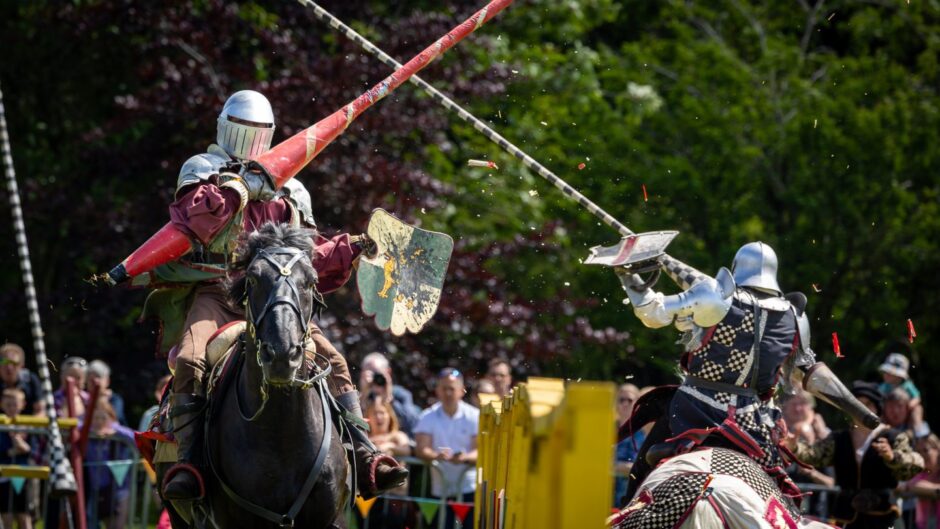 Jousting involving two people dressed as knights on horseback at the Bruce Festival in Dunfermline