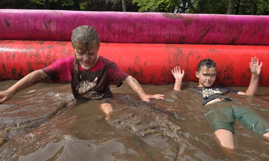 Best friends Ollie Wilson and Emily Denholm get pretty muddy at Race for Life Fife.