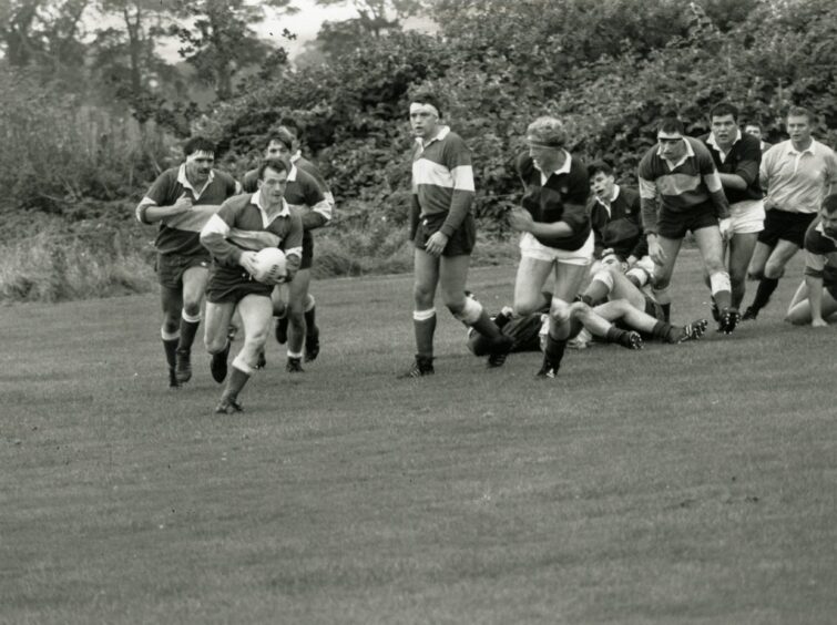 Players chasing the ball as Dunfermline take on Dundee High Former Pupils in October 1990.