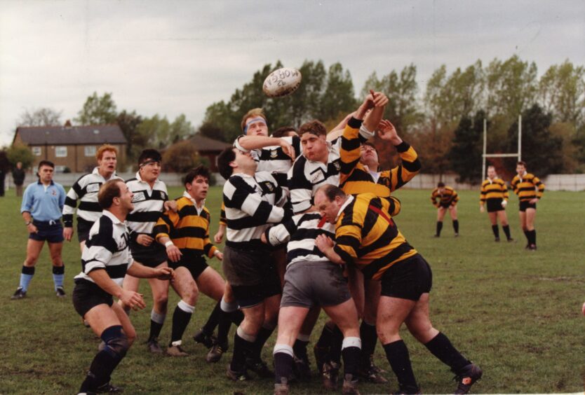players competing for the ball, which is in the air after a line out.