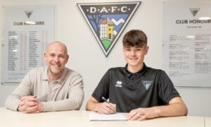 Dunfermline Athletic CEO and chairman David Cook sits beside Lucas Fyfe as the youngster signs his new contract.