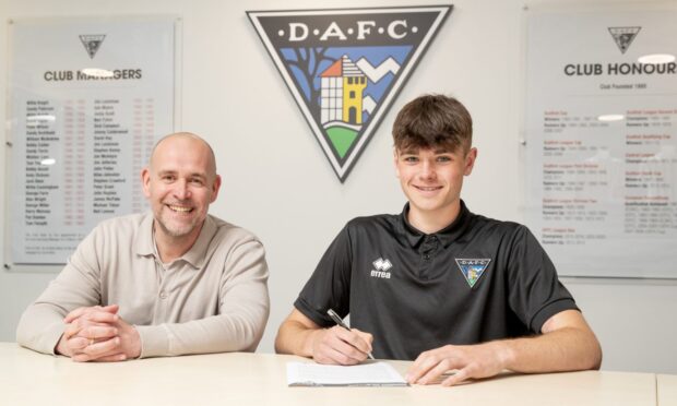 Dunfermline Athletic CEO and chairman David Cook sits beside Lucas Fyfe as the youngster signs his new contract.