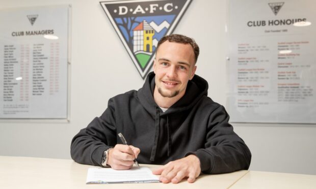 Chris Hamilton signs his new Dunfermline Athletic contract.