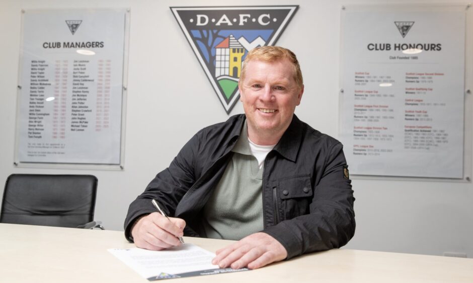 A smiling Neil Lennon signs his new Dunfermline Athletic contract.