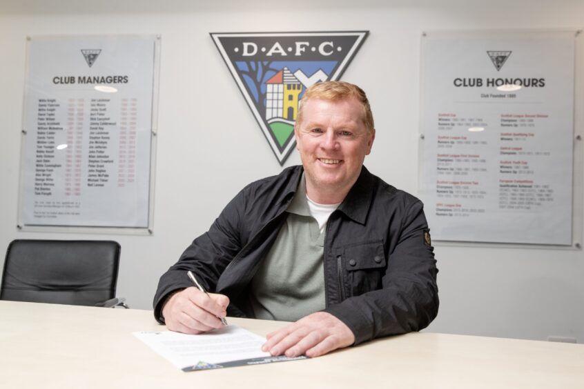 Neil Lennon smiles as he signs his new Dunfermline Athletic contract.