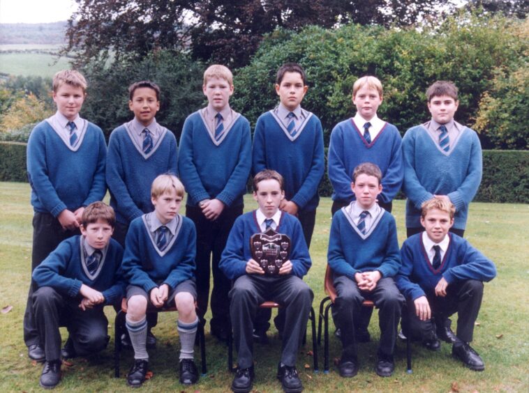 Craigclowan team members lining up for a picture in the school grounds.