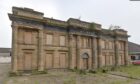 The derelict Watts of Cupar building is boarded up.