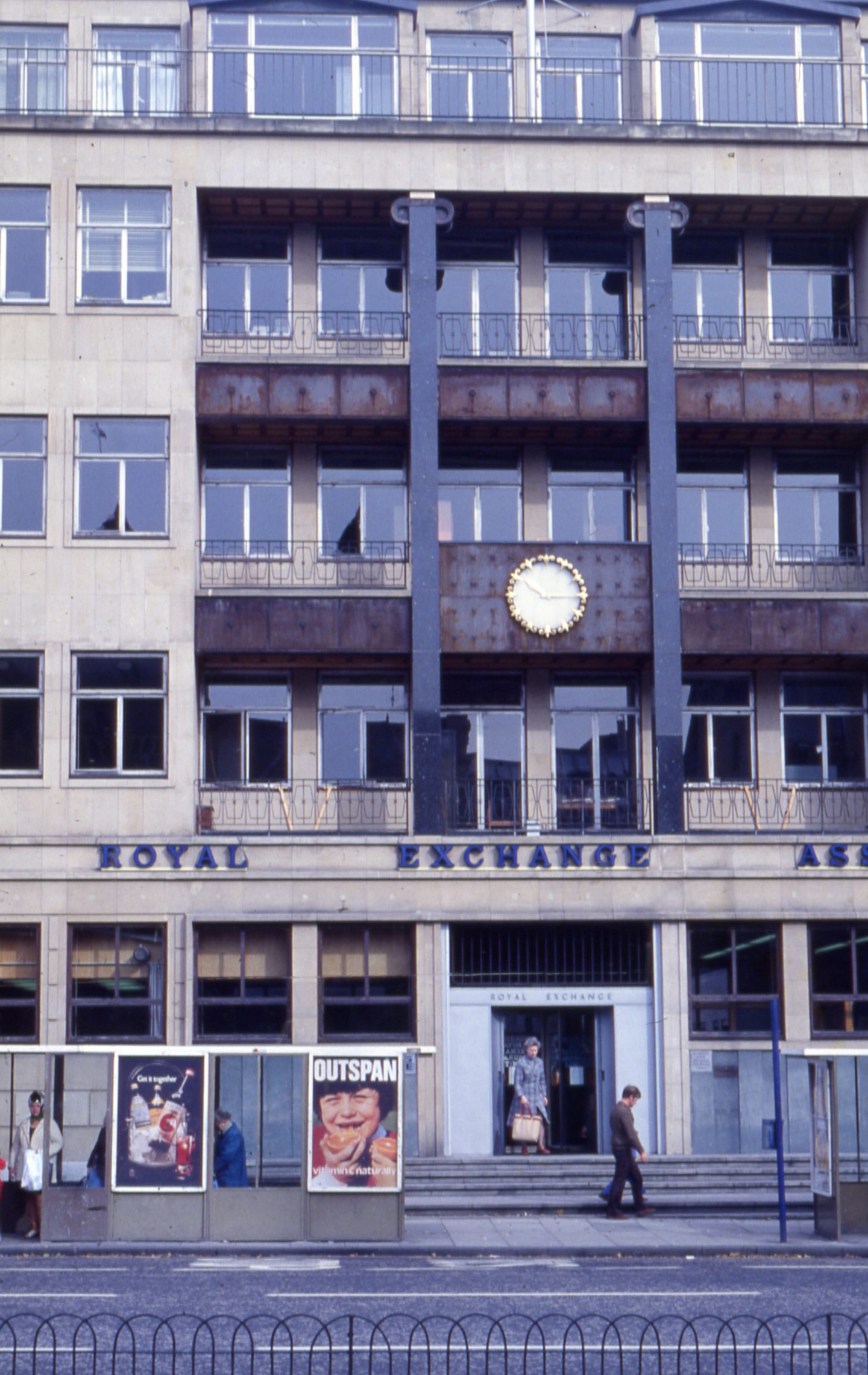 Royal Exchange Assurance building on Panmure Street and people at a bus stop.