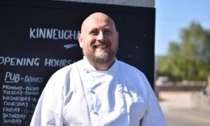 Chef James Ferguson smiling while standing outside.