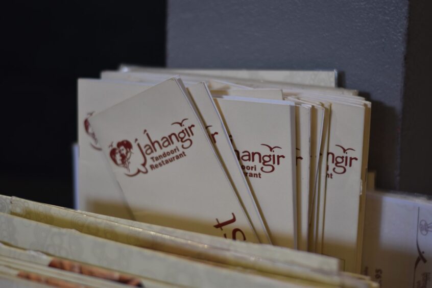Indian takeaway menus being stored in a box.