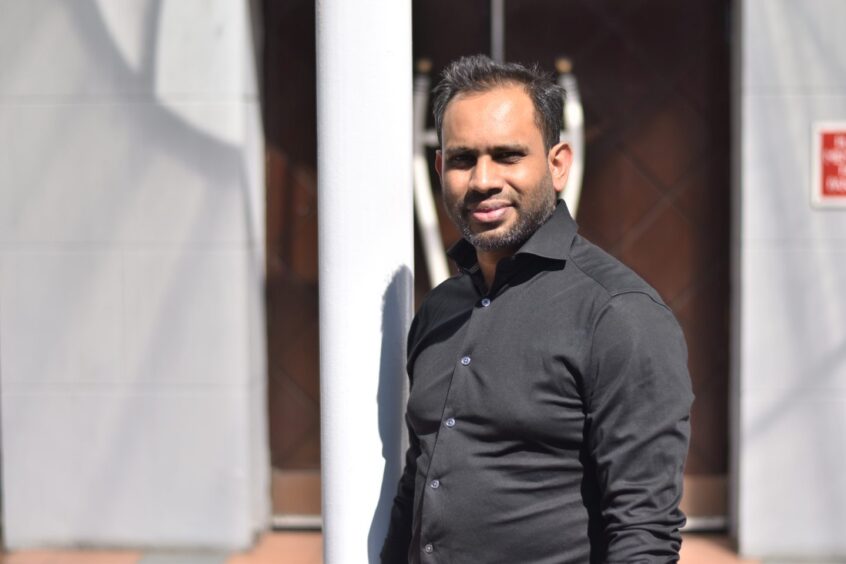 Tanbir Ahamed, manager of Jahangir, standing outside the restaurant.