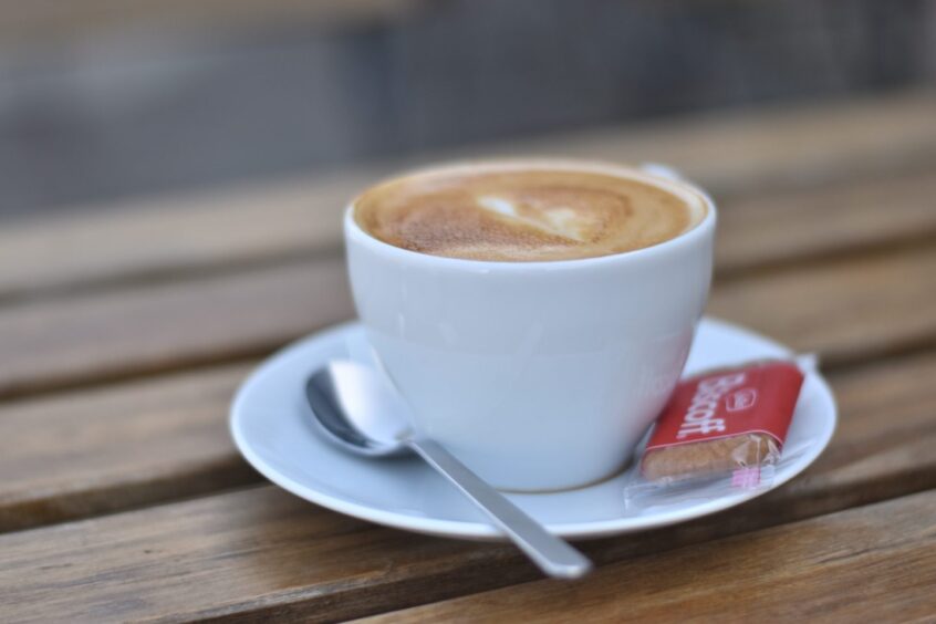 A flat white, sitting on a table.