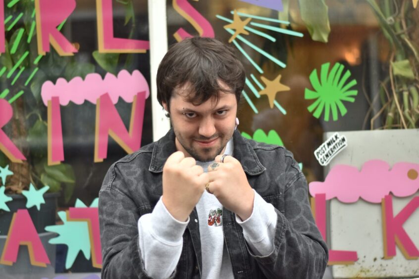 A man playfully posing with his fists up.