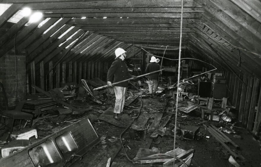 Firefighters inspect the charred interior of the former Fountain disco in Dundee.