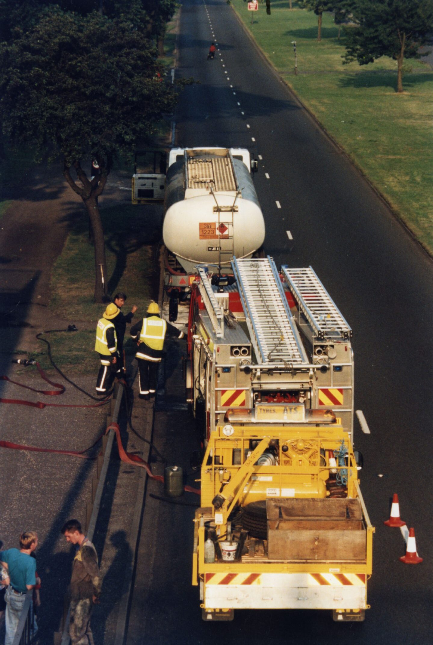an aerial shot showing a fire engine parked behind a tanker as firefighters attend a tanker fuel leak on the Kingsway in Dundee in August 1995.