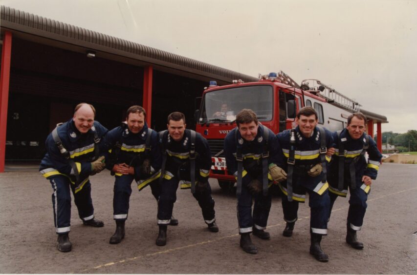 6 Dundee firefighters pictured in front of a fire engine outside a fire station