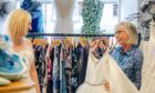 Shop manager Ruth Mackay helps Debbie Clarke pick out some gowns to try. Image: Eve Conroy/DC Thomson.