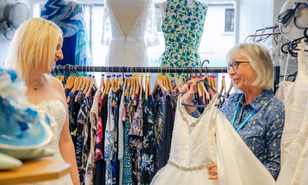 Shop manager Ruth Mackay helps Debbie Clarke pick out some gowns to try. Image: Eve Conroy/DC Thomson.