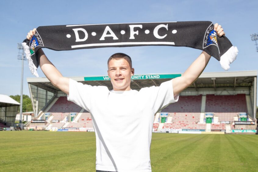 Pars youngster Ewan McLeod holds up a DAFC scarf.