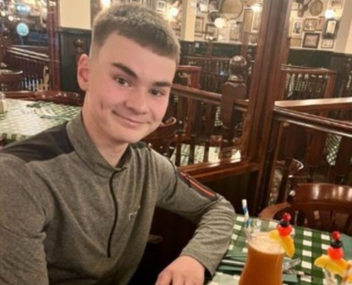 Family photo of Flynn Milne seated at restaurant table
